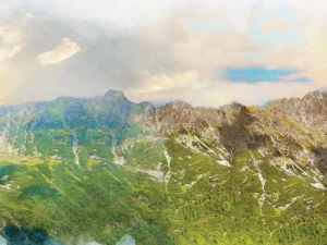 Mountain landscape with lush greenery, dramatic cliffs, and glowing sky.