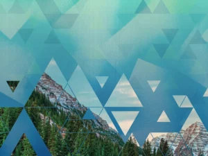 Geometric overlay reveals snowy mountain peaks and forest beneath gradient sky.