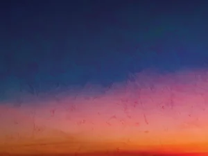 Atmospheric gradient blending deep blue into warm pink, orange, and gold.