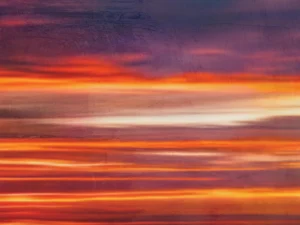 Radiant bands of orange, gold, and deep blue evoke the glow and motion of a dramatic sunset horizon.