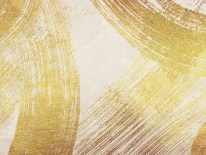 Bold gold brushstrokes sweep across a neutral backdrop, creating a textured, modern composition.