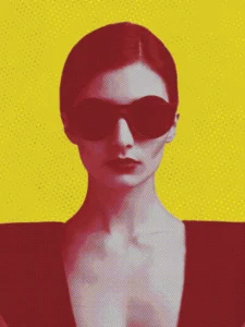 Bold portrait of a woman in sunglasses set against a vivid yellow background.