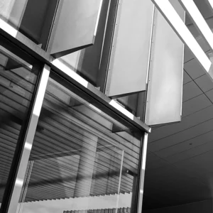 Architectural detail in black and white, showcasing reflection, shadow, and linear composition.