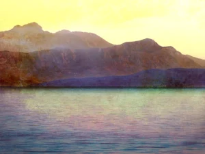 Sunlit mountains rise above calm waters, blending warm and cool textured tones.