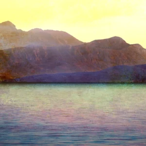 Sunlit mountains rise above calm waters, blending warm and cool textured tones.
