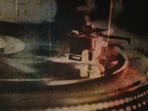 Spinning record whispers timeless melodies, blending vintage warmth with textured memories.