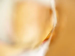 Golden hues blur softly, revealing warmth and delicate curvature through abstract macro focus.
