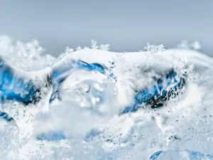 Crystalline water surges upward, capturing fluid motion frozen in shimmering clarity.