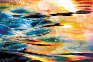 Sunlight reflected on the surging blue emulates burning waves.