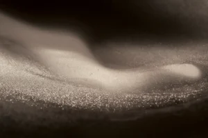 Gilded grains of the finest sand swirl and shift from waves to mist and back in perpetuity.