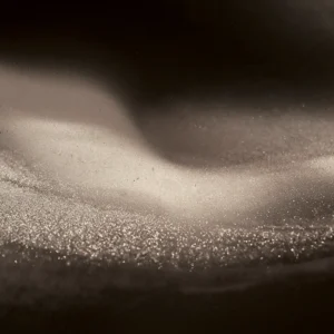 Gilded grains of the finest sand swirl and shift from waves to mist and back in perpetuity.