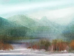 Frothy waves lap against amber forestry at the base of a misty mountain.