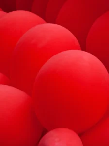 A collection of vibrant red balloons.