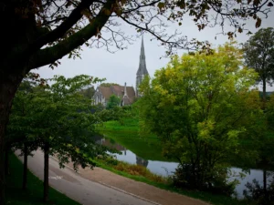 Distant shot of St. Alban's church through the foliage.